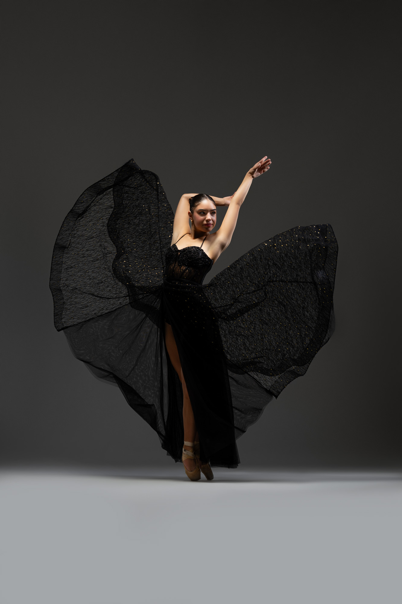 Ballet dancer photographed in a flowing black costume by DFW Dance Photography