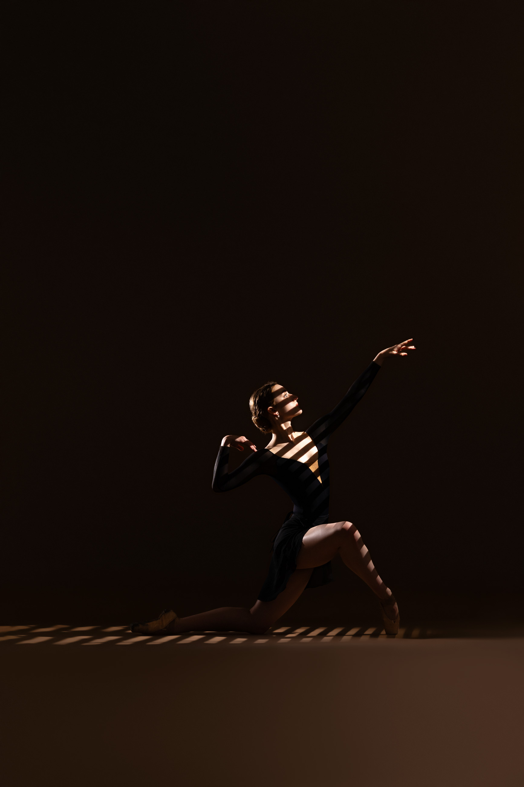 Dancer photographed with dramatic directional lighting by DFW Dance Photography