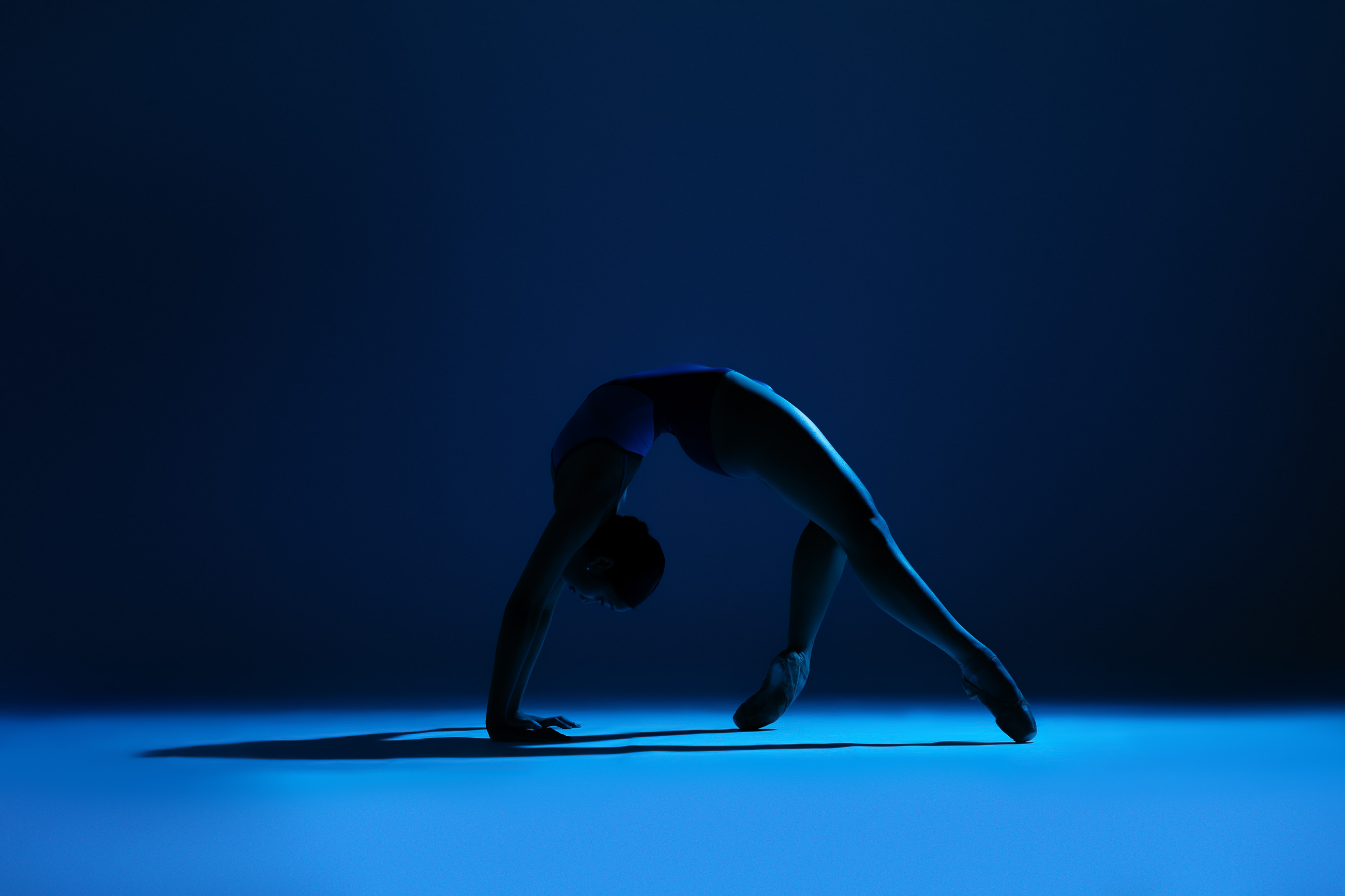 Dramatic blue dance silhouette by DFW Dance Photography