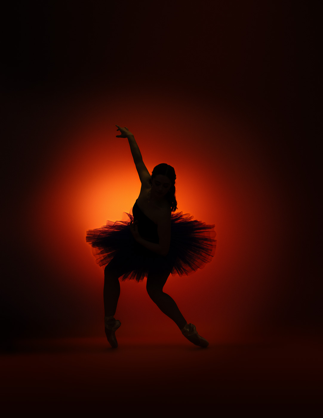 Dramatic orange silhouette dance portrait by DFW Dance Photography